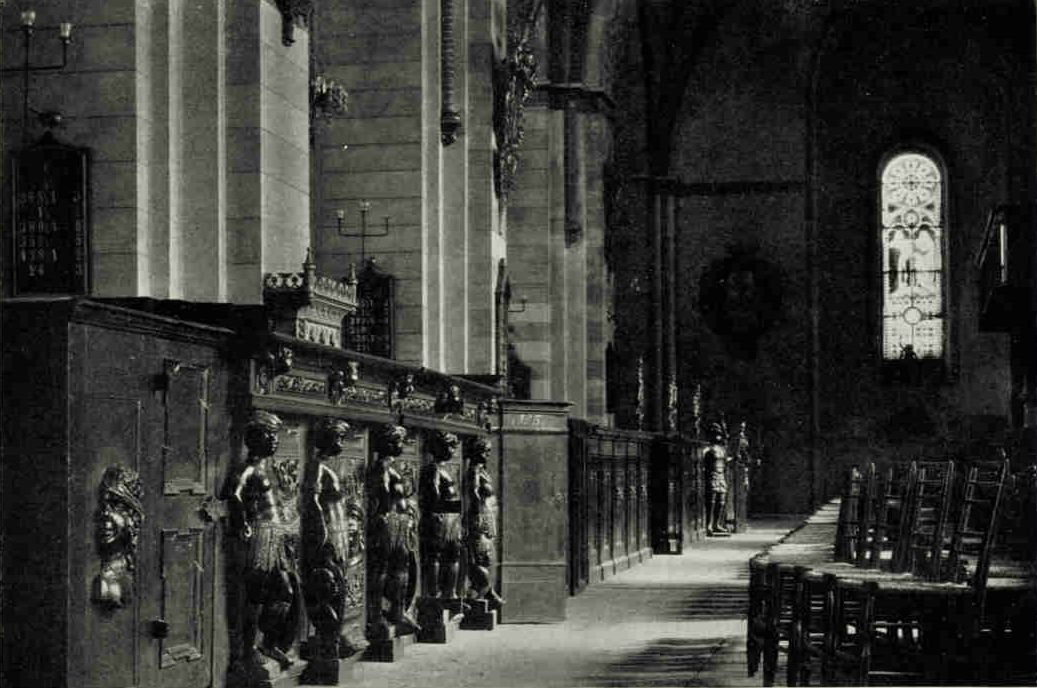 Interior of The Cathedral of The Virgin, in RigaOn the left of the aisle of this brick church, begun in 1211, are the pews belonging to the Blackheads, a society of bachelors of the better class who enjoyed considerable influence during the fifteenth century, with the kinky-haired Moor's head, their insignia, much in evidence (see text, page 401). This peculiar emblem of the order was probably adopted because Maurice, their patron saint, was usually considered a Moor.Photograph by Maynard Owen William