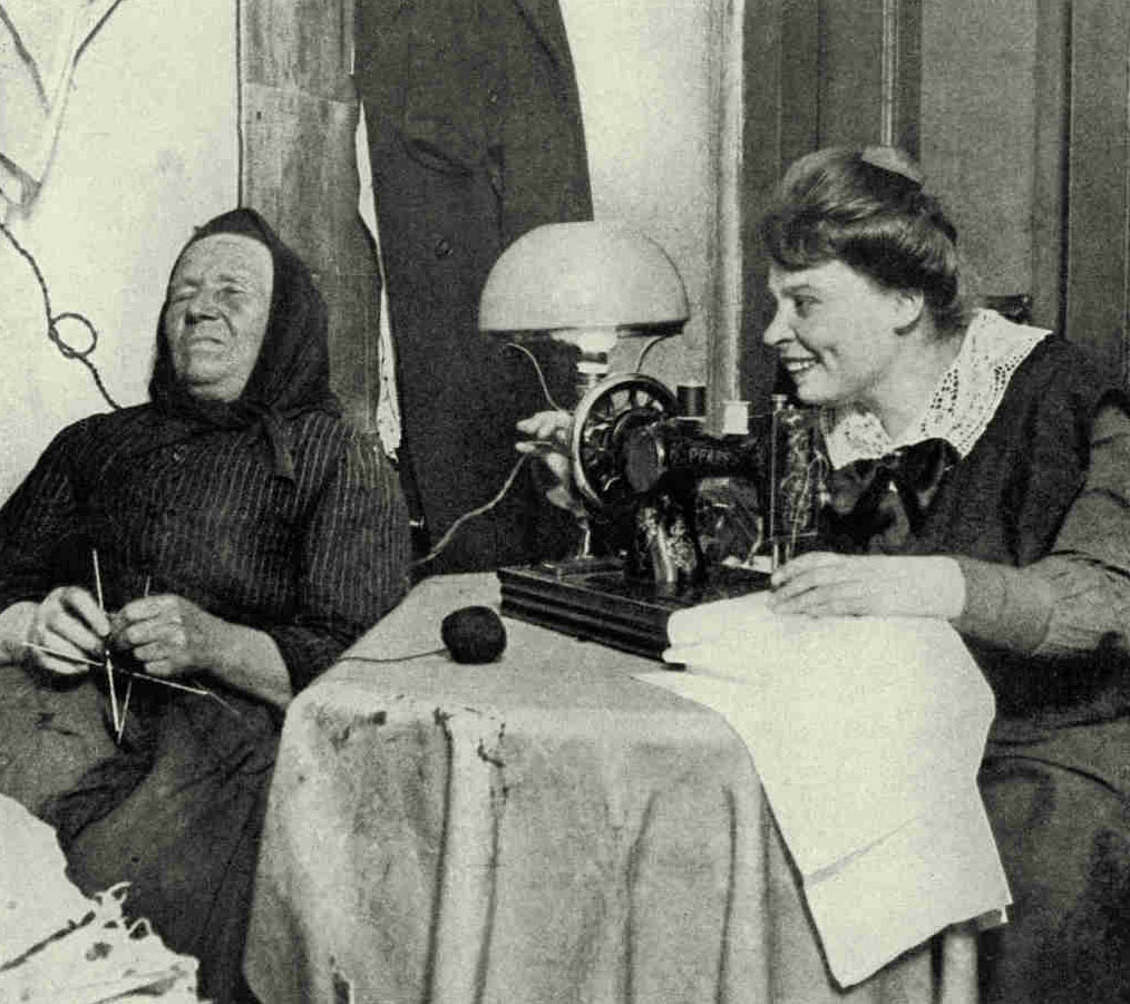 The Old Scorns The NewMother at the left sticks to her knitting and will have nothing to do with the new-fangled sewing machine. But she is not in touch with the spirit of the Latvian Republic, which is eagerly buying American-made plows, harvesters, tractors, and textile machinery. The new Government even went so far as to purchase tractors to lend out in war-devastated districts to facilitate reconstruction work.Photograph by Klio