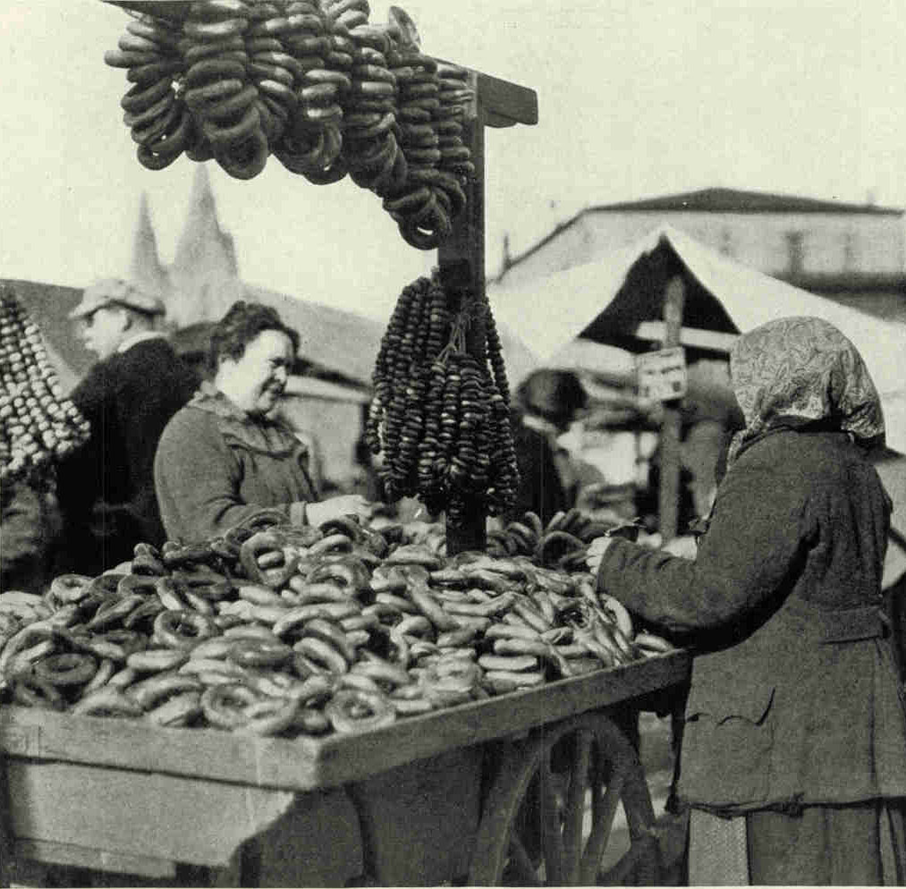 A Few of The Dozen or So Varieties of Bread Offered in The Liepaja MarketVarious forms of bread, ranging from pea-shooter ammunition, through wedding and teething rings and ring-toss circles, to life-preservers, are ordinarily displayed. The balloon-tire variety in the photograph is Russian and tastes like a combination doughnut, educator biscuit, and hard-tack (see text, page 418).Photograph by Maynard Owen Williams