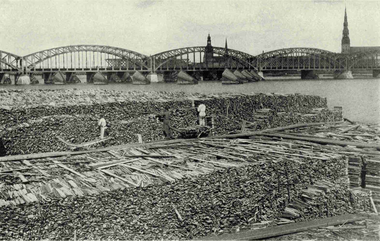 The Lower End of The Island of Hasenholm, With The Railway Bridge and The Steeples of Riga in The DistanceMuch of Latvia's valuable wood crop is annually turned into manufactured products. Five of the Republic's large paper mills export part of their output to Soviet Russia, England and United States.Photograph by Maynard Owen Williams
