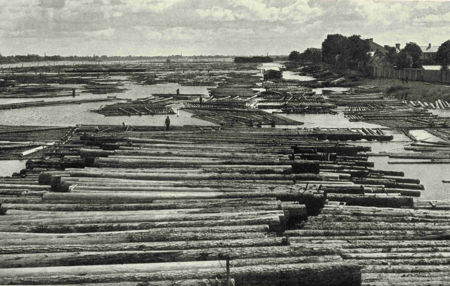 Lumber Rafts in The Daugava River Above The Riga Railway BridgeHasenholm Island is almost a lumber raft itself, with piles of timber stretching as far as one can see and a fringe of floating logs nearly touching the opposite shores.Photograph by Maynard Owen Williams