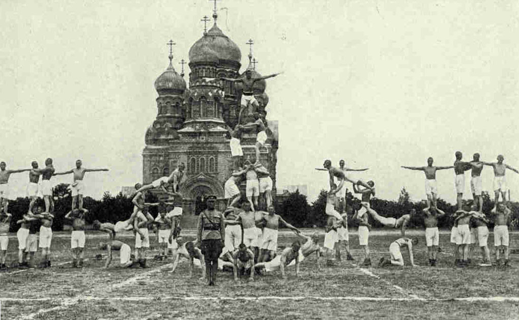 Physical Drill at Kara Osta, The War Harbor of LiepajaDown near the sea clean-limbed young athletes exercise in the stadium, which occupies a former fort, and the fine friendship between the young men and the fresh-cheeked, deep-lunged girls is a joy to see. Hundreds of these young people every year emigrate to the United States.Photograph by Henry Kurskops
